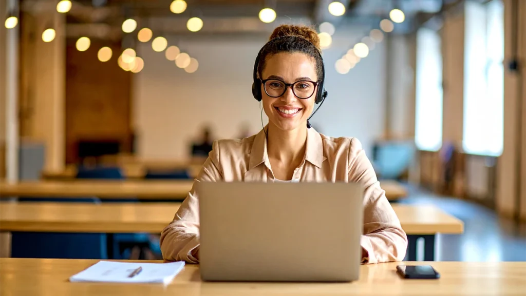 Eine junge Kieferorthopädin sitzt am Laptop und nimmt am Webinar „KFO-Spezial für Existenzgründer” teil.