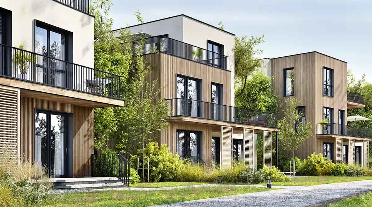 Moderne Wohnhäuser im Grünen als Beispiel für geeignete Kapitalanlage-Immobilien.